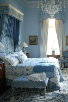 a bedroom with blue walls and curtains, a chandelier hanging from the ceiling