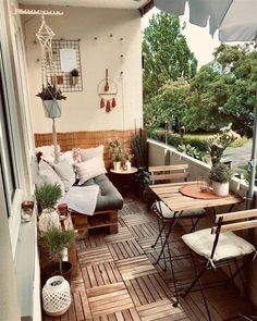 an outdoor patio with wooden flooring and furniture