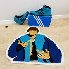 a pair of blue shoes sitting on top of a wooden floor next to a rug