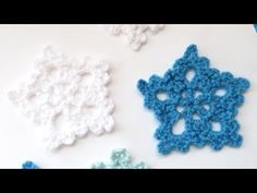 three crocheted snowflakes sitting next to each other