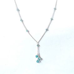 Three beautiful aqua with purple haze bicone crystals cascade down a delicate silver plated chain with matching crystal accents. Available with gold plated or gunmetal grey chain upon request. Dainty Crystal Dangle Necklaces, Elegant Light Blue Necklace With Beaded Chain, Silver Jewelry With Dangling Teardrop Pendant, Elegant Light Blue Beaded Chain Jewelry, Elegant Light Blue Beaded Jewelry, Elegant Blue Dangle Crystal Necklaces, Silver Drop Crystal Necklace With Adjustable Chain, Silver Crystal Dangle Lariat Necklace, Silver Crystal Lariat Necklace With Dangle