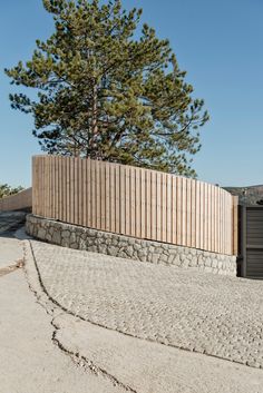 a wooden fence next to a tall tree