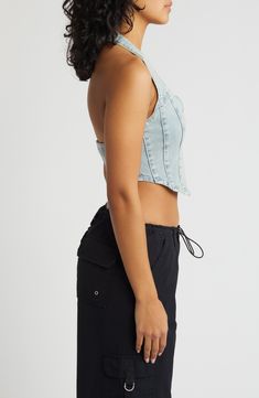 Amp up your edge in this cropped halter top designed in light-wash denim with a zip closure and corset-inspired details. 8 1/2" center front length (size Medium) Front zip closure Halter neck 95% cotton, 4% polyester, 1% spandex Machine wash, line dry Imported Cropped Denim Corset For Summer, Fitted Light Wash Cropped Top, Casual Cropped Cotton Corset, Spring Cropped Denim Corset, Light Wash Fitted Denim Crop Top, Light Wash Cropped Denim Crop Top, High Waist Denim Crop Top In Medium Wash, Fitted Light Wash Denim Crop Top, Fitted Washed Blue Cropped Denim Top