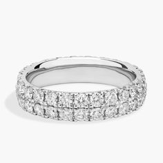 a white gold ring with rows of round diamonds on the sides and an invisible band