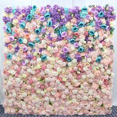 a large flower wall with many different colored flowers on it