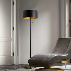 a living room with a chaise lounge chair and floor lamp