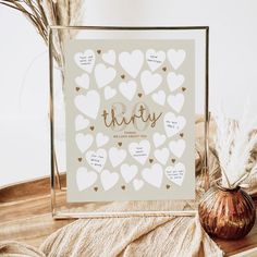 there is a glass frame with hearts on it and the words thirty written in cursive writing