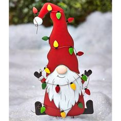 a red gnome with christmas lights on it's head