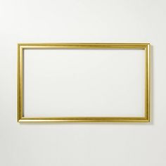 an empty gold frame hanging on the wall