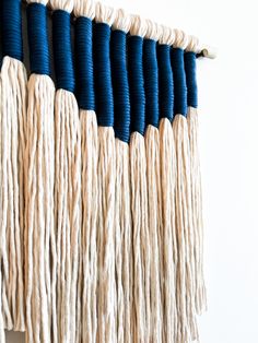 blue and white wall hangings with yarn on them