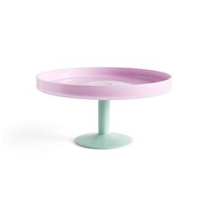 a pink and green cake plate sitting on top of a table