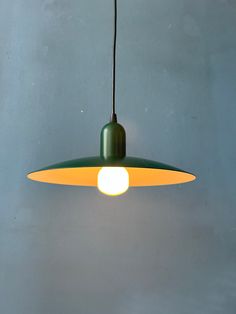 a green and yellow light hanging from a ceiling