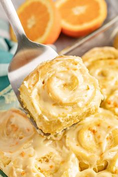 a close up of a spoon with some food on it and oranges in the background