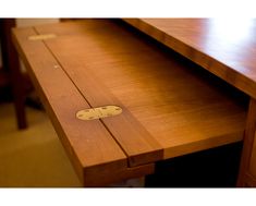 a close up of a wooden desk with a drawer