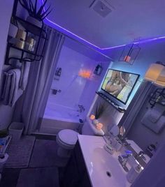 a bathroom with a television on the wall