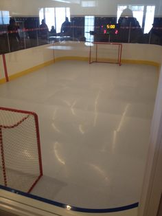 an indoor hockey rink with net and goal