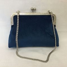 Elegant evening bag in rich Light Navy Blue Luxe Velvet fabric. Silver metal purse frame with matching detachable 22" silver chain allows this bag to be carried on the shoulder, over the arm or in your hand as a clutch. This handbag is sturdy enough to stand up on it's own or be folded down for easy packing when travelling. The outer fabric is polyester Luxe velvet (light weight upholstery fabric), the lining is a pink and blue cotton print and bag is interfaced with cotton canvas to give it a n Metal Shoulder Bag For Evening, Elegant Blue Bag With Chain Detail, Elegant Metal Rectangular Shoulder Bag, Elegant Rectangular Metal Shoulder Bag, Blue Evening Bag With Chain Detail, Formal Metal Shoulder Bag With Chain Strap, Chic Metal Shoulder Bag For Formal Occasions, Silver Metal Bag For Events, Chic Formal Metal Shoulder Bag