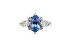 a blue and white diamond ring with three diamonds on the side, set in 18k white gold