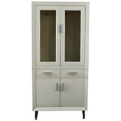 a white cabinet with two doors and drawers