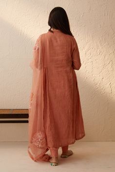 Peach chanderi tissue with V neck, side gathered panels and fringe tassel details. Paired with tapered pant, silk organza dupatta with all over floral dori, thread, sequin embroidery and inner slip.
Components: 4
Pattern: Embroidered
Type Of Work: Dori, Thread and Sequin Work
Neckline: V Neck
Sleeve Type: Anarkali: Three Quarter Sleeves, Inner Slip: Sleeveless
Fabric: Anarkali: Tissue, Pant: Chanderi, Dupatta: Silk Organza
Color: Peach
Other Details: 
Panelled anarkali
Occasion: Puja,Work - Aza V Neck Anarkali, Peach Anarkali, Tapered Pant, Chanderi Dupatta, Sequin Embroidery, Embroidered Dupatta, Organza Dupatta, Sequins Embroidery, Silk Organza