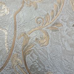 an intricately designed wallpaper with gold and silver designs on the outside of it