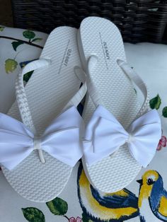 These beautiful flip flops are wrapped with white ribbon, and adorned with a white Satin Bow with a double pearl strip on one straps. Ribbon color is white, if you are needing other colors of ribbon or decoration please contact me and will be happy to accommodate you!  Flip Flops can be made for child and adult size. All flip flops are handmade to order and the production time is 1 to 2 weeks business days and then please allow time for shipping. Amazing for beach, weddings, flower girl or a fan White Synthetic Flip Flops For Beach, White Synthetic Beach Flip Flops, White Non-slip Flip Flops For The Beach, Adjustable Bow Sandals For Beach, White Adjustable Non-slip Sandals, Adjustable White Sandals For Beach, White Adjustable Sandals For Beach, White Non-slip Sandals For Beach, White Non-slip Beach Sandals