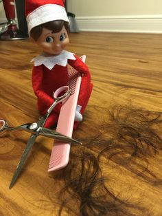 an elf is sitting on the floor with scissors and hair in front of her,