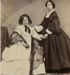 an old photo of two women sitting next to each other