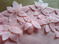 pink felt flowers with pearls on them