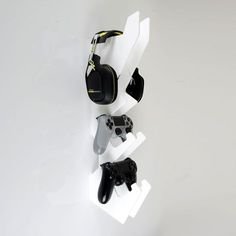 several video game controllers are hanging on the wall with headphones attached to each one