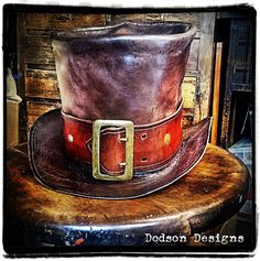 You can't get more stylish than a hand-crafted leather top hat! These hats are made entirely by hand. And can be customized to suit your costume or look. Whether you want to go with a badass biker look, a steampunk, or another genre, this leather hat adds a ton of character to your costume or look. I make these out of genuine full-grain vegetable-tanned leather. Each hat is hand-dyed and then stitched by hand to your needs.  A simple hat bad is included in the price, but a more creative and fanc Vintage Fitted Top Hat For Cosplay, Vintage Top Hat With High Crown For Cosplay, Vintage High Crown Top Hat For Cosplay, Handmade Vintage High Crown Top Hat, Fitted High Crown Top Hat For Cosplay, Vintage Fitted Hat For Cosplay, Fitted Vintage Hat For Cosplay, Fitted High Crown Hat For Cosplay, High Crown Cosplay Hat