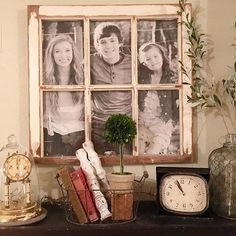 an old window is decorated with family photos, books and other items on a mantle