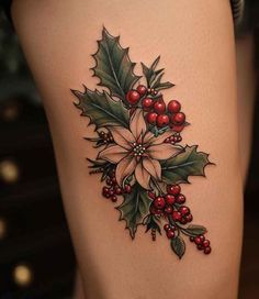 a woman's thigh with holly and poinsettia tattoo on the side