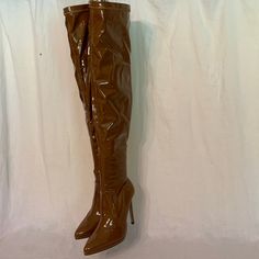 Striking, “Wet Look”, Vinyl, Stiletto, Boots. Very Tall, Very Shiny, Very Soft, Beautiful Caramel Color Thigh Boots. Features Ankle Zipper On Inside. 4.5” Heel, .5” Platform, 27” From Heel Tip To Top. Ankle Circumference Is About 8 1/2”, Top Circumference Is 19”, Midway Circumference Is 14” Boots Are Brand New. Bt-54 Thigh Boots, Thigh High Boots Heels, Thigh Boot, Stiletto Boots, Boots Heels, Caramel Color, Wet Look, Shoe Dazzle, Thigh High Boots