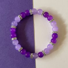 pretty purple bracelet to add to an everyday look Purple Beaded Bracelets Greatergood, Cheap Purple Beaded Bracelets For Festivals, Affordable Purple Beaded Bracelets, Cheap Purple Beaded Wristband, Cheap Casual Purple Beaded Bracelets, Purple Jewerly Beads, Cheap Purple Friendship Bracelets With Spacer Beads, Cheap Purple Stretch Bracelet With Round Beads, Cheap Personalized Purple Beaded Bracelets