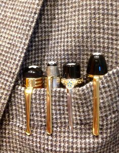 three rings are attached to the lapel of a suit coat and tie clip holder