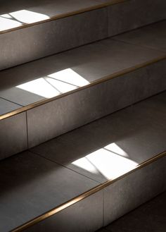 sunlight shining through the windows on some stairs