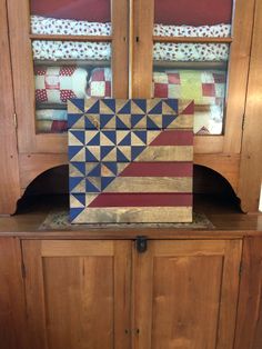 a wooden block sitting on top of a cabinet