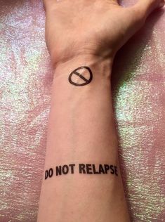 a woman's arm with a tattoo saying do not relapse