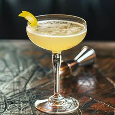 a yellow drink sitting on top of a wooden table