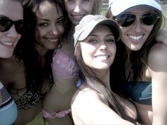 a group of young women taking a selfie in the sun with their camera phone