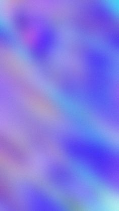 a blurry image of an airplane flying in the sky with purple and blue colors