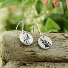 Description Ferns are some of the oldest plants and date back hundreds of millions of years ago. Some ferns even have a life span of 100 years. These plants are strong, adaptable, and withstand the test of time. Wear these earrings as a symbol of your resilience and unwavering strength. Details Recycled sterling silver. Size = 1/2" (1.2cm) long. Fern Earrings, Fern Frond, Silver Fern, Pretty Pendant, Sun And Stars, Saddle Leather, Dangly Earrings, Recycled Sterling Silver, Lily Of The Valley