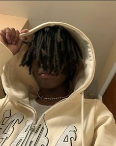 a person with dreadlocks wearing a hoodie