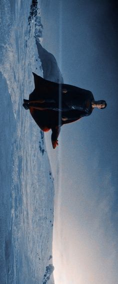 a person standing on top of a snow covered slope