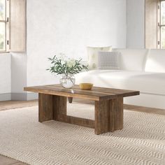 a living room with a white couch and wooden coffee table