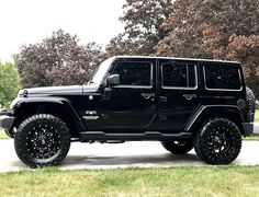 a black jeep is parked on the street