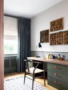 a room with a desk, chair and pictures on the wall above it that have been decorated in shades of green