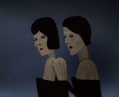 two women in black and white are facing each other