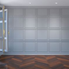 an empty room with wood flooring and white walls, painted in shades of gray